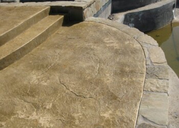 Stamped concrete patio with stone border by water in ECD Concrete work. Stamped concrete patio with stone border near water in ECD Concrete project.