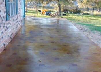 Finished acid stained concrete patio at a home in Eads, Tennessee. Concrete patio with acid stain finish outside a brick house in Eads, Tennessee.