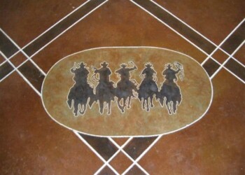 Concrete floor with custom horse engraving in a home or business setting. Custom engraved design of five horses on a concrete floor.