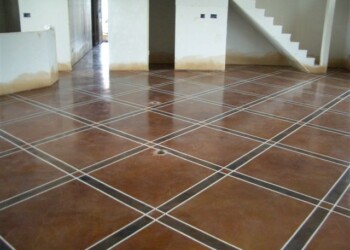 Finished decorative concrete floor with grid pattern in a home in Eads, Tennessee. Decorative concrete floor with grid pattern in a residential interior.