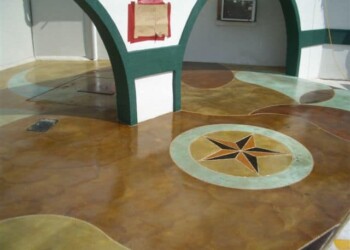 Custom concrete floor with star and circle designs in a residential space. Decorative concrete floor with star and circle patterns in a room.