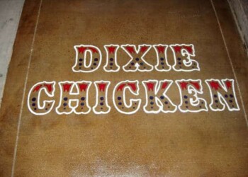Custom engraved sign for Dixie Chicken restaurant in College Station, TX. Decorative wooden sign reading 'DIXIE CHICKEN' with patriotic colors and patterns.