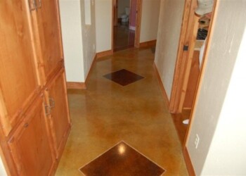 Finished concrete floor with acid stain in a home hallway in Eads, Tennessee. Interior view of a concrete floor with acid stain finish in a home hallway.