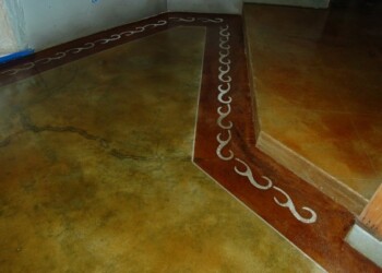 Concrete floor with acid stain and decorative border in a home. Interior concrete floor with acid stain and decorative border in a residential space.