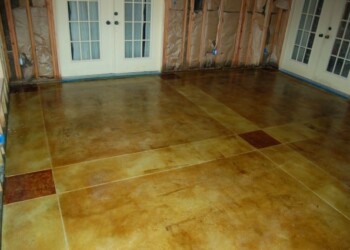 Finished acid stained concrete floor in a residential interior in Eads, Tennessee. Interior of a room with freshly acid stained concrete floor in a warm earth tone palette.