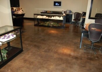 Finished acid stained concrete floor in a commercial office in Eads, Tennessee. Interior of a commercial space with acid stained concrete floor in a brown tone.