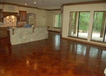 Finished acid stained concrete floor in a home in Eads, Tennessee. Interior view of a home with freshly acid stained concrete floor in a spacious open area.