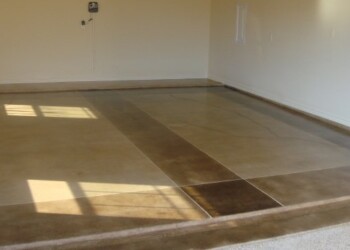 Concrete floor with acid stain in a home, showing a polished, decorative finish. Interior concrete floor with acid stain finish in a residential space.