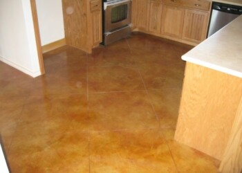 Kitchen showing the finished acid stained concrete floor in a warm brown color. Kitchen with newly acid stained concrete floor in a warm brown tone.