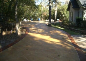 Concrete driveway with acid stain finish in a residential neighborhood. Concrete driveway with acid stain finish in a residential neighborhood.