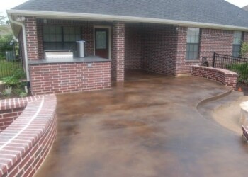 Concrete patio with acid stain finish at a home in Euless, Texas. Finished exterior acid stained concrete patio at a residential home in Euless, Texas.