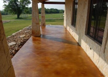 Finished acid stained concrete porch at a home in Eads, Tennessee. Exterior concrete porch with acid stain finish in a residential area.