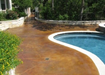 Acid stained concrete pool deck in a backyard in Eads, Tennessee. Concrete pool deck with acid stain finish in a backyard setting.