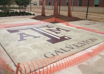 Concrete with Galveston logo and name, under construction, surrounded by orange safety fencing. Concrete with Galveston logo and name, under construction, surrounded by orange safety fencing.