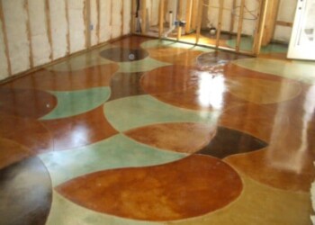 Decorative concrete floor with colorful patterns in a home under construction. Colorful decorative concrete floor with curved patterns in a construction site.