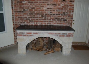 New granite countertop installed on a brick fireplace in Ephrata home. Brick fireplace with a new dark granite countertop in a home in Ephrata.