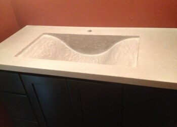Concrete bathroom vanity with a built-in sink, installed in a bathroom. Concrete bathroom vanity with a built-in sink in a modern style.