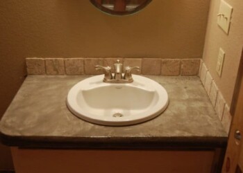 Bathroom sink with granite countertop and brick backsplash. Bathroom sink with granite countertop and brick backsplash in a home.