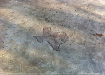 Stamped concrete in Texas shape on a driveway in Euless, Texas. Concrete surface with a Texas-shaped stamped pattern.
