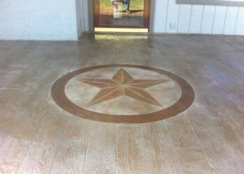 Decorative star stamped concrete design on a porch in a residential home. Stamped concrete floor with a star design in front of a door.