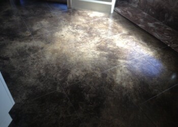 Interior acid stained concrete floor in a home in ECD, showcasing a polished, decorative finish. Concrete floor with acid stain finish in a residential interior.