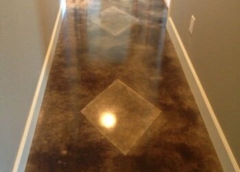 Polished concrete floor with diamond-shaped inlays in a hallway. Polished concrete floor with diamond-shaped inlays in a hallway.