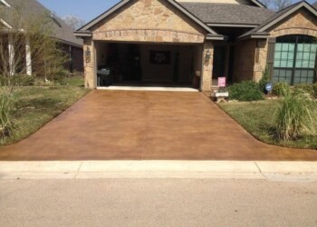 Concrete driveway with acid stain finish in front of a house in Euless, Texas. Concrete driveway with acid stain finish in front of a house in Euless, Texas.
