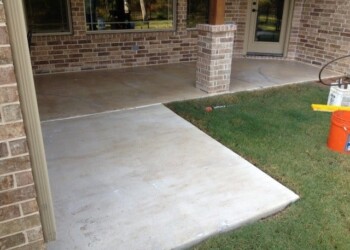 Stamped concrete overlay on porch at a residential home in Euless, Texas. Concrete stamped overlay on porch with brick house background in Euless, Texas.