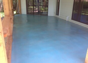 Finished acid stained concrete floor in a sunroom in Eads, Tennessee. Interior concrete floor with acid stain in blue-green shades in a sunroom.