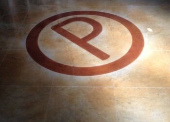 Custom engraved parking space symbol on concrete floor at ECD Concrete in town. Parking space symbol painted on a concrete floor at ECD Concrete.
