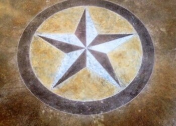 Star-shaped inlay design on concrete floor in a construction site. Concrete floor with a star-shaped inlay design in a circular border.