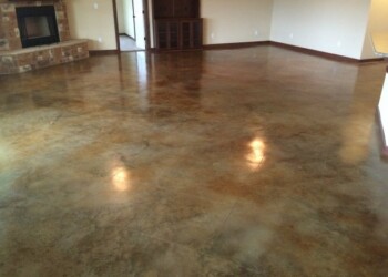 Polished acid-stained concrete floor in a living room of a home. Interior of a room with polished acid-stained concrete floor in a residential home.