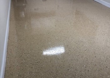 Newly coated epoxy garage floor in a residential home in Ephrata. Finished beige epoxy garage floor coating in a residential space.