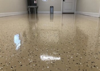 Epoxy garage floor coating completed in a residential garage in Ephrata, PA. Finished epoxy garage floor with beige base and black and white speckles in a residential garage.