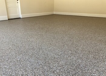 Garage floor coated with epoxy in a residential property in ECD, providing a smooth, durable surface. Finished garage floor with durable epoxy coating in a residential home.