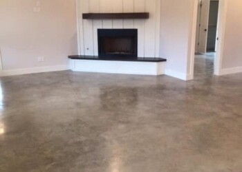 Finished polished concrete floor in a living room with fireplace in ECD Concrete project. Polished concrete floor in a living room with a fireplace and modern decor.