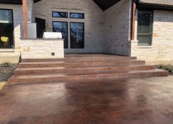 Concrete steps and porch with acid stain finish at a home in Euless, Texas. Exterior concrete steps and porch with acid stain finish in a residential home.