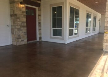 Finished concrete porch with acid stain in Eads, Tennessee, for a smooth, decorative surface. Concrete porch with acid stain finish at a residential home in Eads, Tennessee.