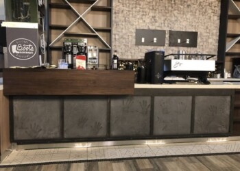Concrete countertop with handprint designs at a coffee shop in Ephrata. Countertop with concrete finish and handprint designs in a coffee shop setting.