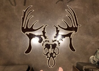 Custom deer skull wall art created for a client in Eads, Tennessee. Decorative wall art of a deer skull with antlers in a workshop setting.