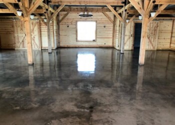 Finished polished concrete floor in a wooden structure, part of a Sealed & Waxed Floors project. Polished concrete floor inside a wooden building with exposed beams.