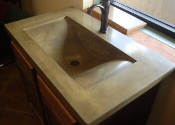 Concrete kitchen sink installed in a kitchen in Ephrata, Pennsylvania. Concrete kitchen sink with a built-in drain and faucet in a modern kitchen.