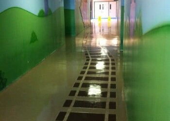 Bright hallway with painted walls and checkered floor at ECD Concrete in town. Colorful hallway with painted walls and a black and white checkered floor pattern.