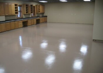 Commercial kitchen space with wooden cabinets and polished concrete floor. Empty commercial kitchen with wooden cabinets and a polished concrete floor.