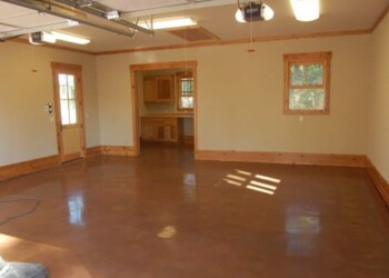 Polished concrete floor in a home in Eads, Tennessee. Finished polished concrete floor in a residential room with wooden trim and windows.