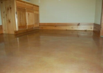 Finished polished concrete floor in a kitchen in Eads, Tennessee. Polished concrete floor in a residential kitchen with wooden cabinets and trim.