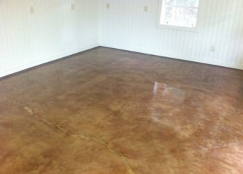 Finished polished concrete floor in a room in ECD Concrete's project in Eustis. Polished concrete floor in a bright room with white walls and a window.