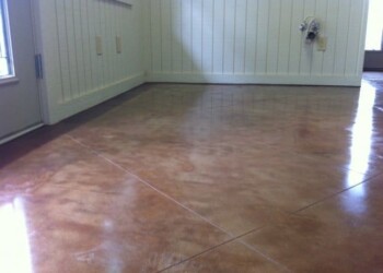Finished polished concrete floor in a room in ECD Concrete, serving the local area. Polished concrete floor in a room with white paneled walls and a window.