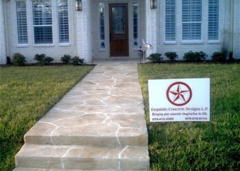 Stamped concrete walkway with a star design, leading to a white house in a residential neighborhood. Stamped concrete walkway leading to a house with a sign for Exquisite Concrete Designs, L.P.